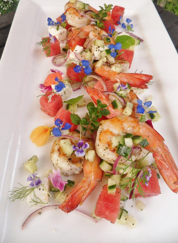 Salad of fresh prawns, watermelon microherbs and flowers and scattered with Finger Lime Superfruit Powder!